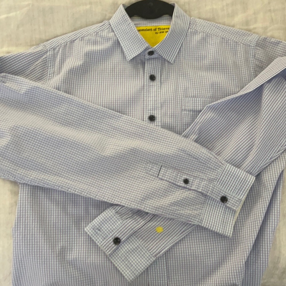 Blue long sleeved shirt. Lines are blue with purple. Chest pocket. Black buttons